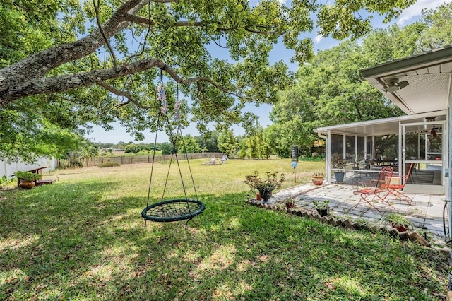 view of yard featuring a patio area, a sunroom, and a rural view