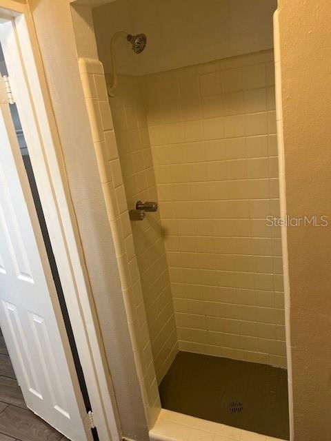 bathroom with a tile shower