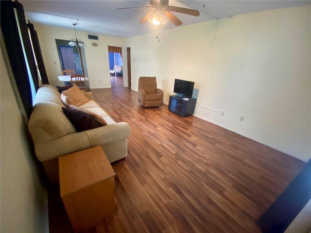 living room featuring hardwood / wood-style floors and ceiling fan with notable chandelier