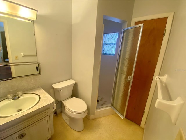 bathroom with vanity, walk in shower, and toilet