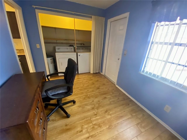 office space with separate washer and dryer and light wood-type flooring