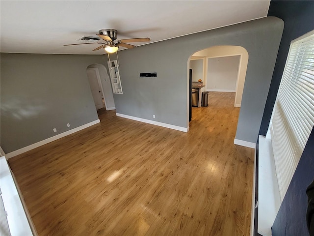 empty room featuring ceiling fan and light hardwood / wood-style flooring