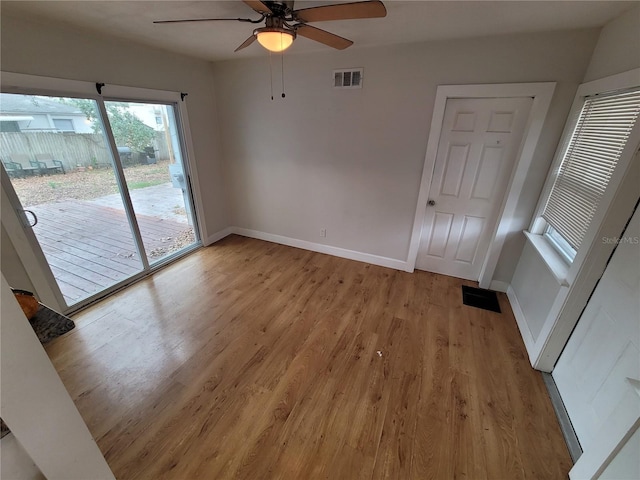 empty room with light wood-type flooring and ceiling fan