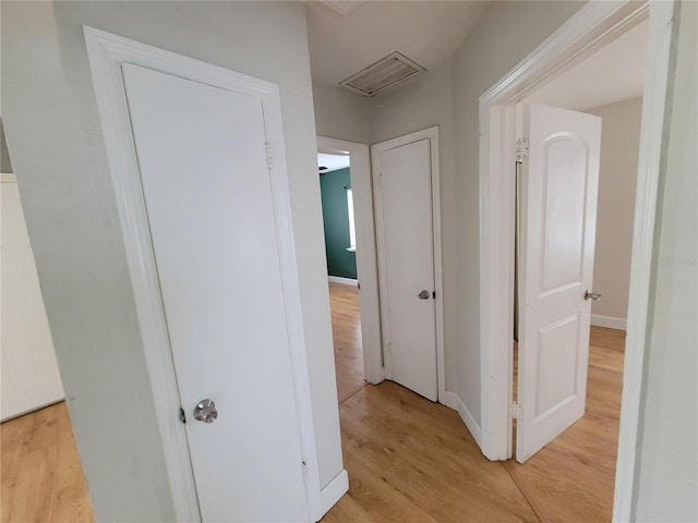 corridor with light wood-type flooring