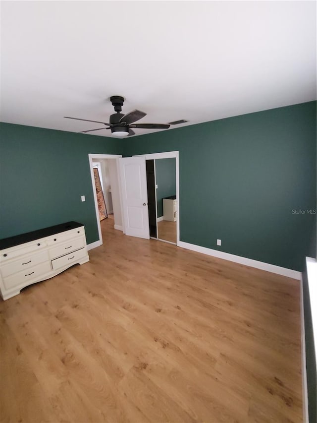 unfurnished bedroom featuring ceiling fan and light hardwood / wood-style flooring