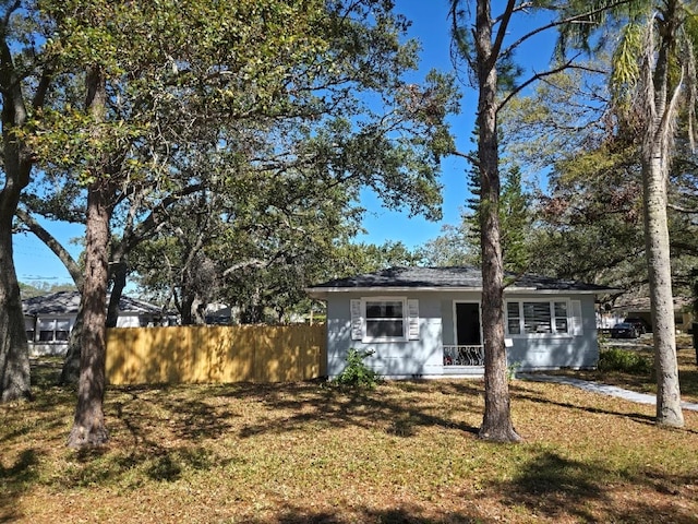 view of front of property with a front lawn and fence