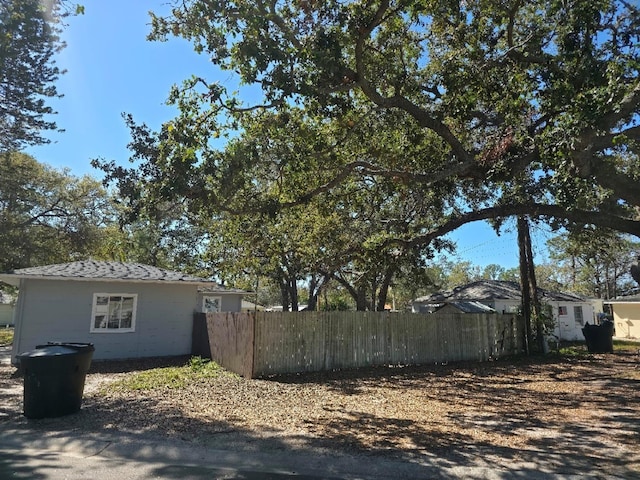 view of side of property featuring fence