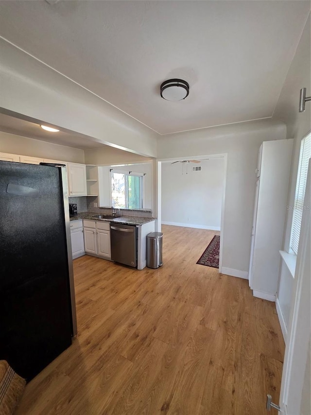 kitchen featuring stainless steel appliances, white cabinetry, baseboards, light wood-style floors, and open shelves