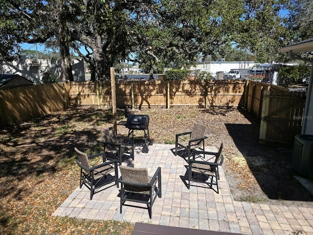 view of patio / terrace with a fenced backyard and central AC