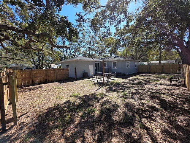 rear view of house featuring a patio and a fenced backyard