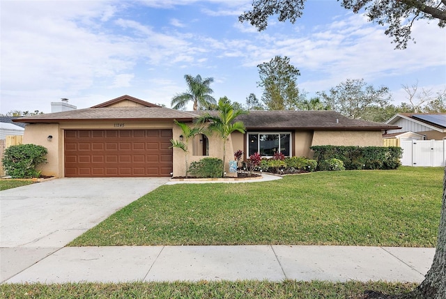 ranch-style house featuring a front lawn and a garage