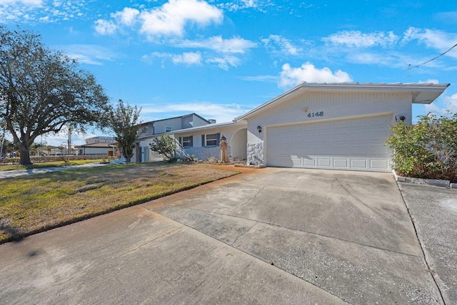 ranch-style home with a front yard and a garage