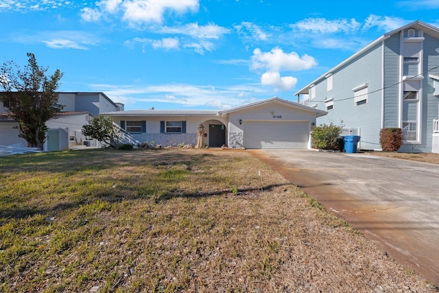 ranch-style home with a front yard and a garage