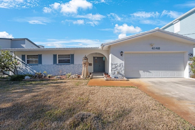 ranch-style home with a front yard and a garage