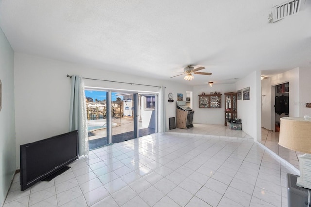 unfurnished living room with ceiling fan and light tile patterned floors