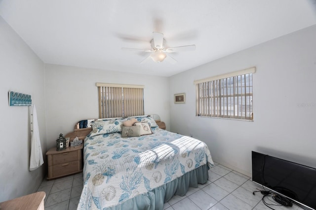 bedroom with ceiling fan and light tile patterned floors