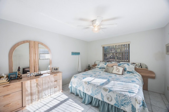 tiled bedroom featuring ceiling fan