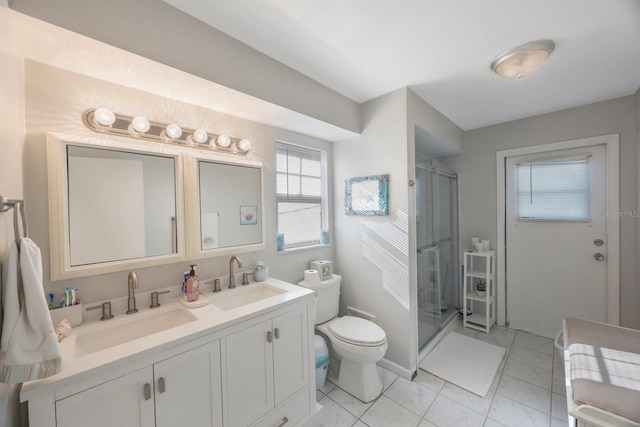 bathroom featuring tile patterned floors, toilet, vanity, and walk in shower