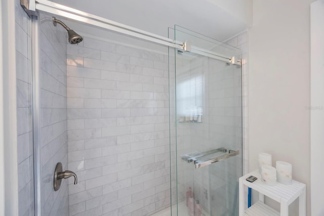 bathroom featuring a shower with shower door