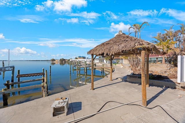 view of dock with a gazebo and a water view