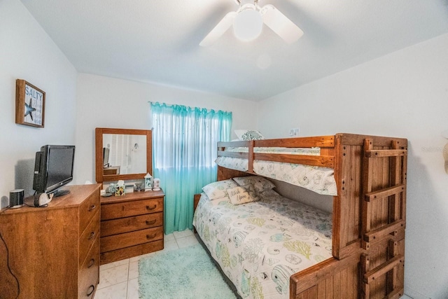 bedroom with ceiling fan and light tile patterned floors