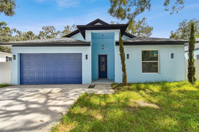 view of front facade featuring a front yard and a garage