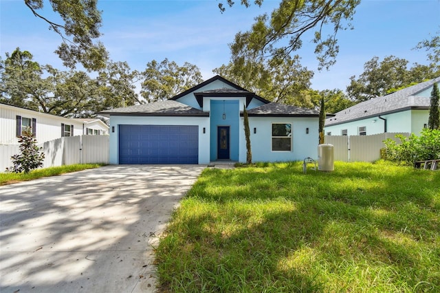 view of front of house featuring a front yard and a garage