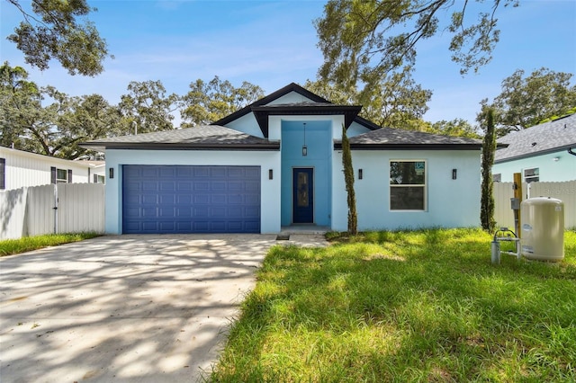 view of front of home with a garage and a front lawn