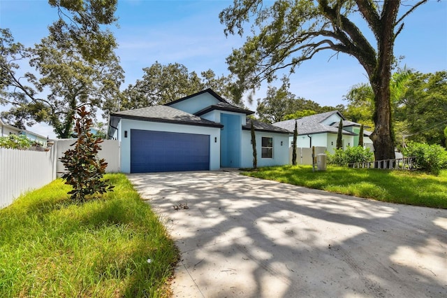 view of front of house featuring a garage and a front lawn