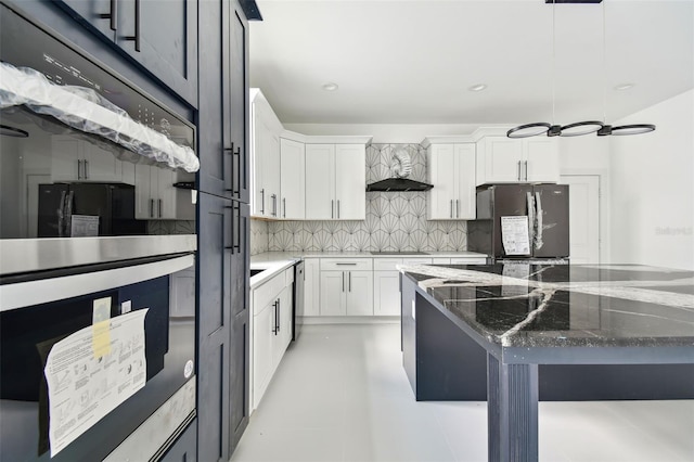 kitchen with tasteful backsplash, dark stone countertops, pendant lighting, white cabinets, and black appliances