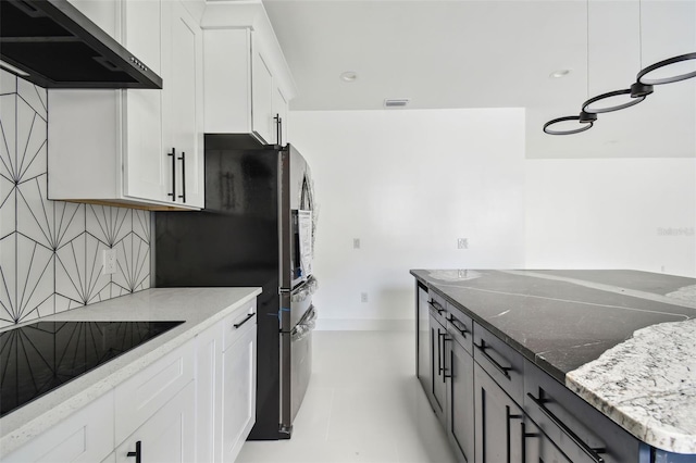 kitchen featuring white cabinets, decorative backsplash, and exhaust hood