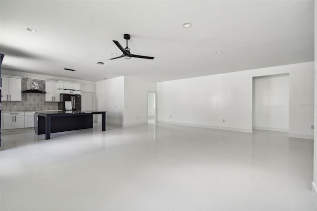 tiled living room with ceiling fan