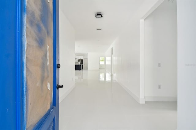 hall featuring light tile patterned floors