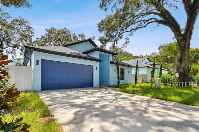 view of front of home with a garage and a front yard