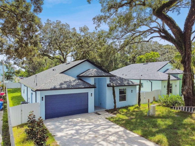 view of front of house with a front yard and a garage