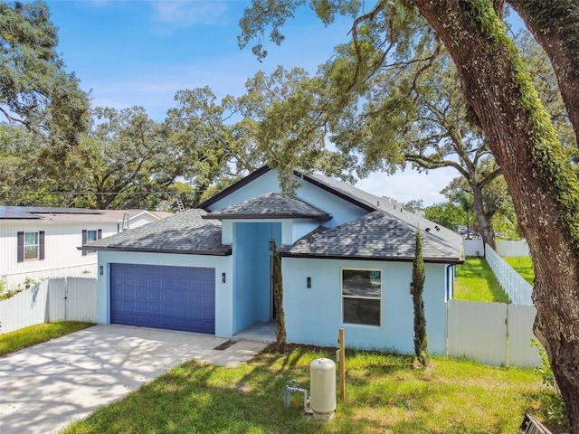 view of front of home featuring a garage and a front lawn