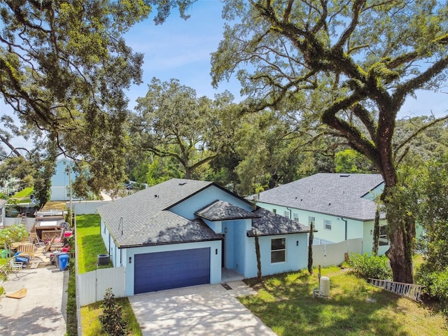 view of front of house featuring a garage and a front lawn