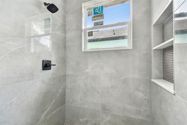 bathroom with tiled shower