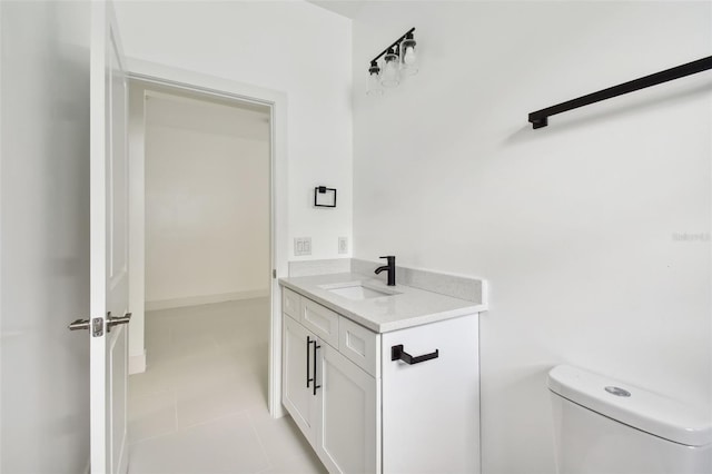 bathroom with tile patterned floors, vanity, and toilet