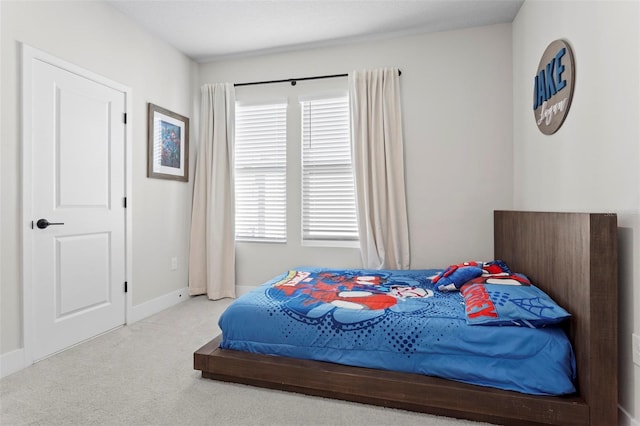 carpeted bedroom featuring multiple windows