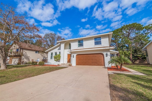 view of front of property featuring a front yard and a garage