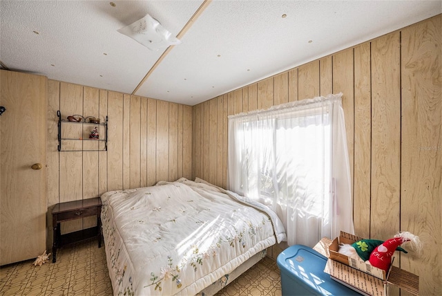 bedroom featuring wood walls