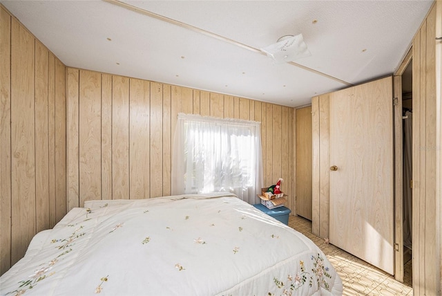 bedroom with wood walls