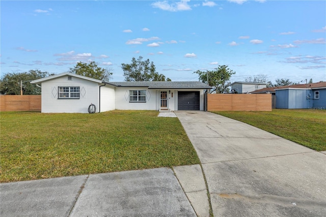 ranch-style home featuring a garage and a front lawn