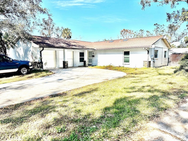 rear view of property with a garage and a yard