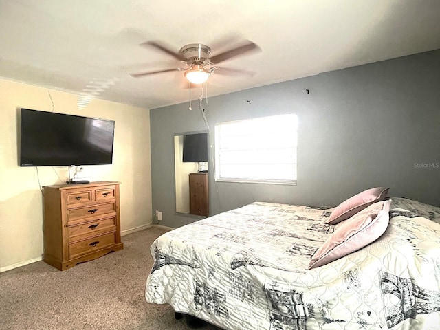 bedroom with ceiling fan and light colored carpet