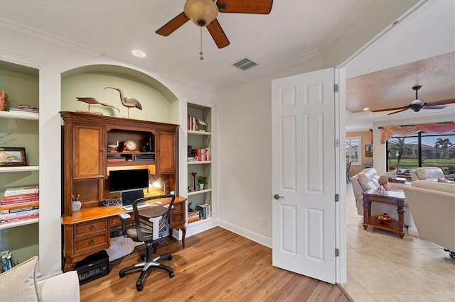 office area with built in shelves, light wood-type flooring, ceiling fan, and ornamental molding