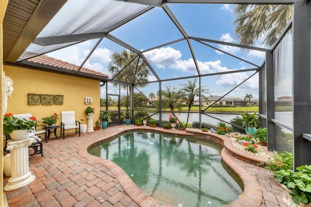 view of swimming pool with a patio, a water view, and a lanai