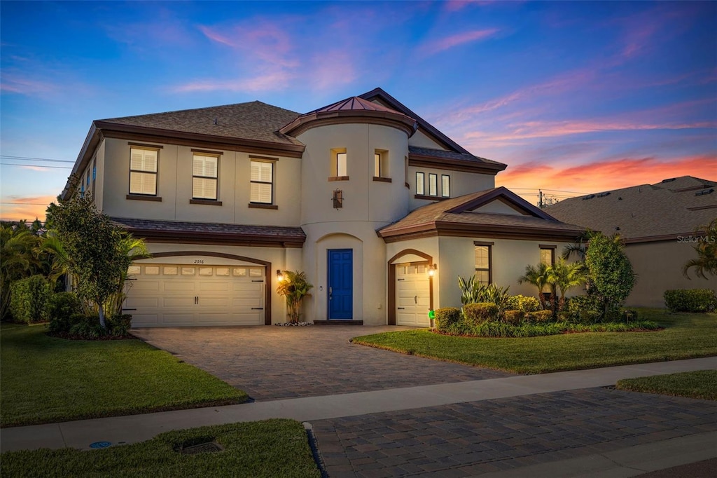 view of front of home with a yard and a garage