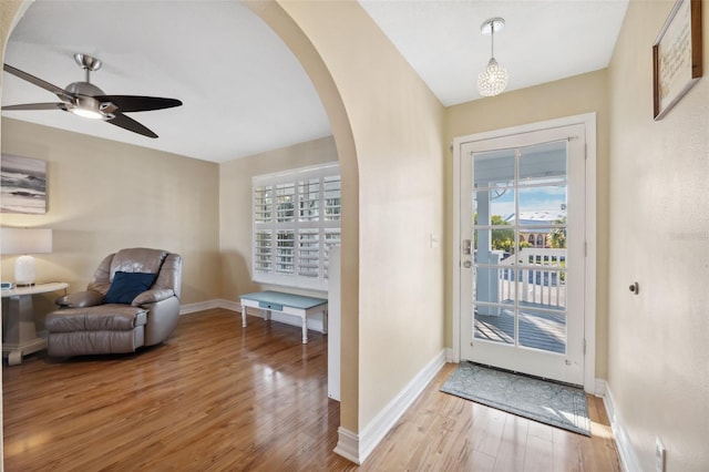 foyer entrance with ceiling fan and light hardwood / wood-style flooring